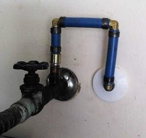 Image of a new PEX water line installed by Honey Bee Plumbing behind the water heater water supply shut off valve.