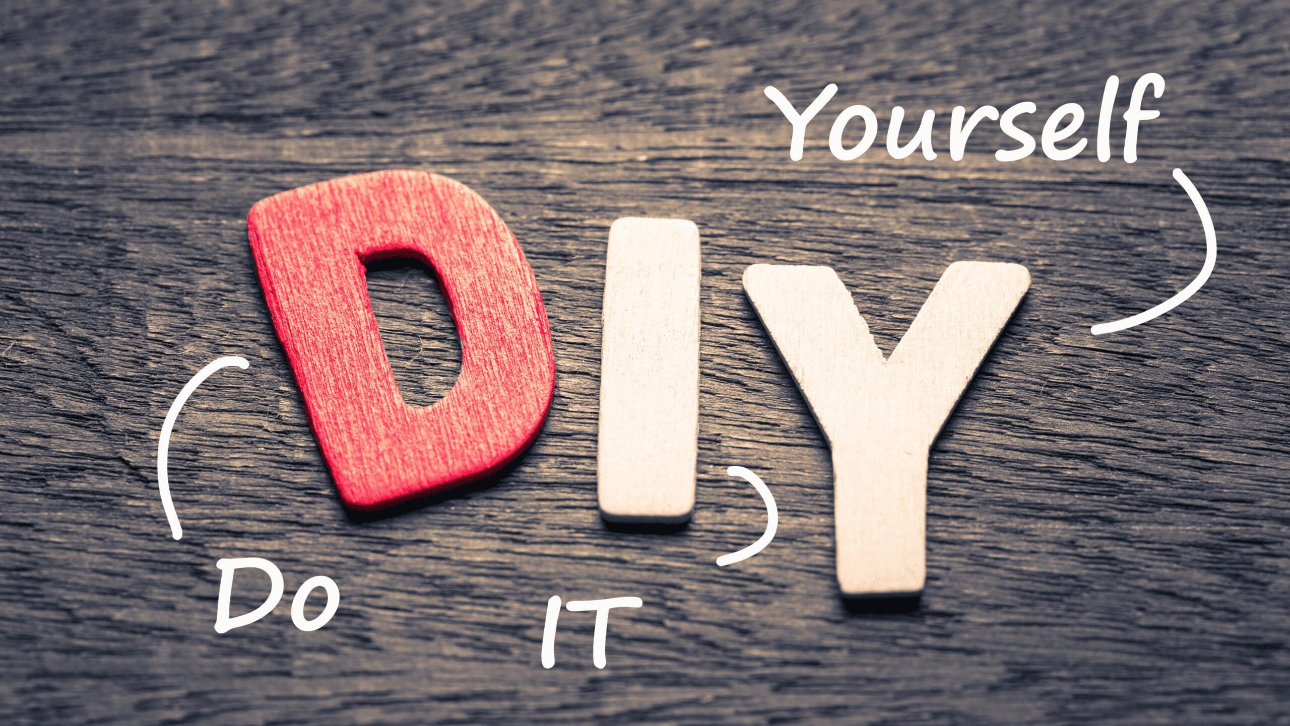 Wooden letters 'D', 'I', 'Y' arranged on a wood table top.