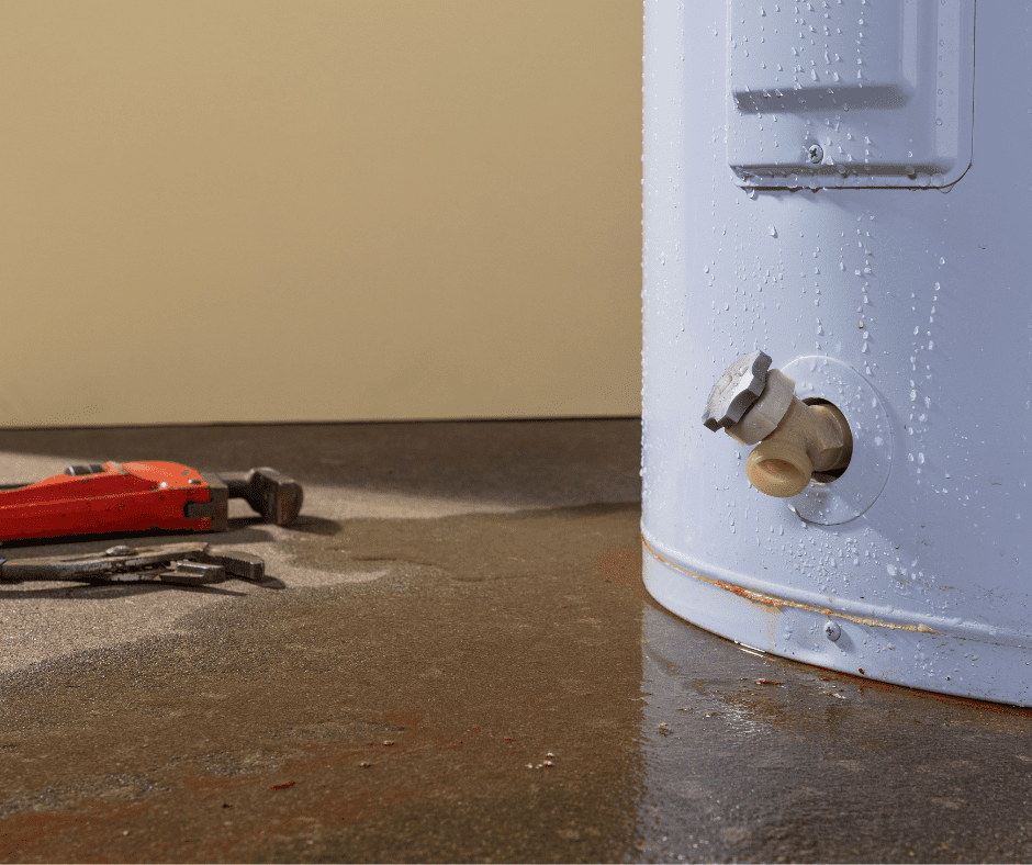 A residential gas tank water heater with visible water leakage around the base.