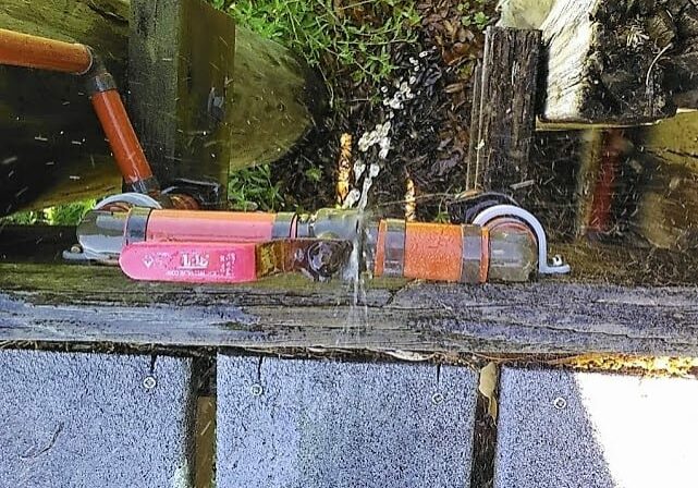 Image of a damaged PEX isolation valve causing water leakage on a Gulf Breeze, Florida home's dock.