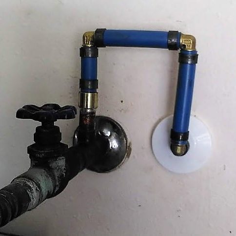 Image of a new PEX water line installed by Honey Bee Plumbing behind the water heater water supply shut off valve.