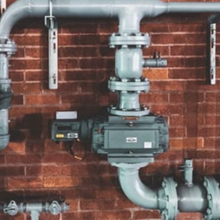 Essential Infrastructure: Gas Piping and Regulators on a Building's Exterior Gas piping and regulators installed on the exterior of a building